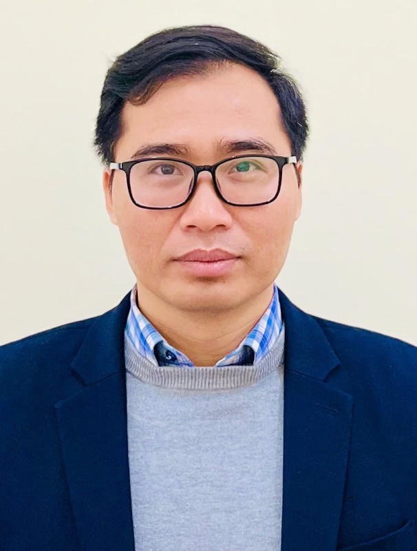 A person wearing glasses and a blue jacket

Description automatically generated