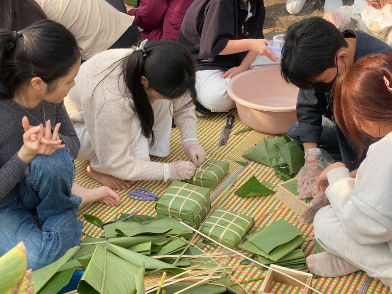 A group of people making food

Description automatically generated